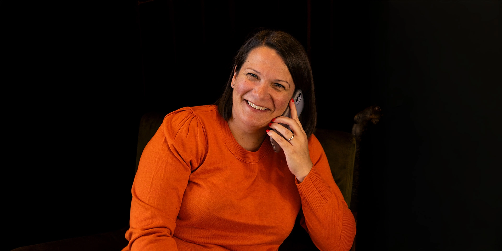 Leisa Pickles taking on the phone and smiling